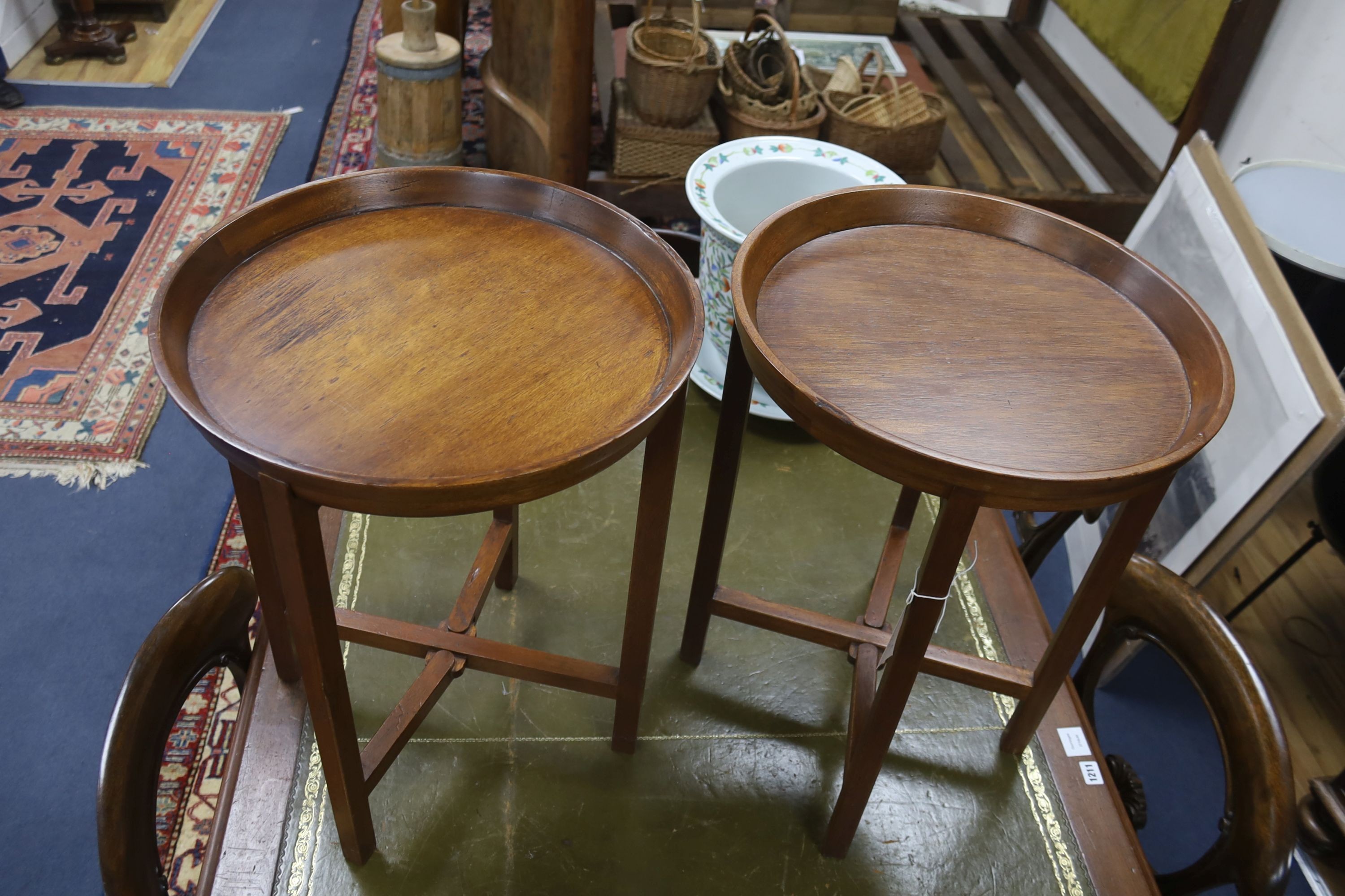 A pair of circular mahogany folding tray top occasional tables, diameter 46cm, height 60cm